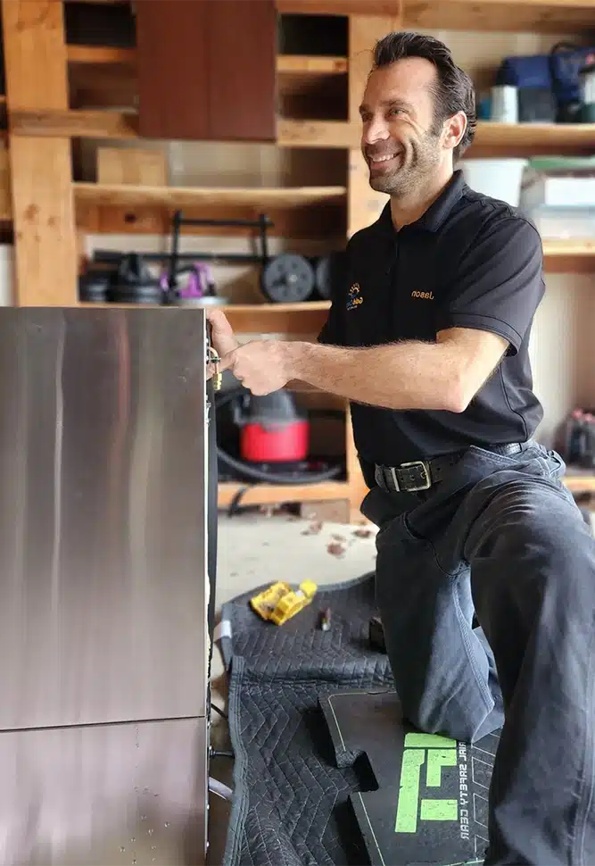 Jason servicing a refrigerator