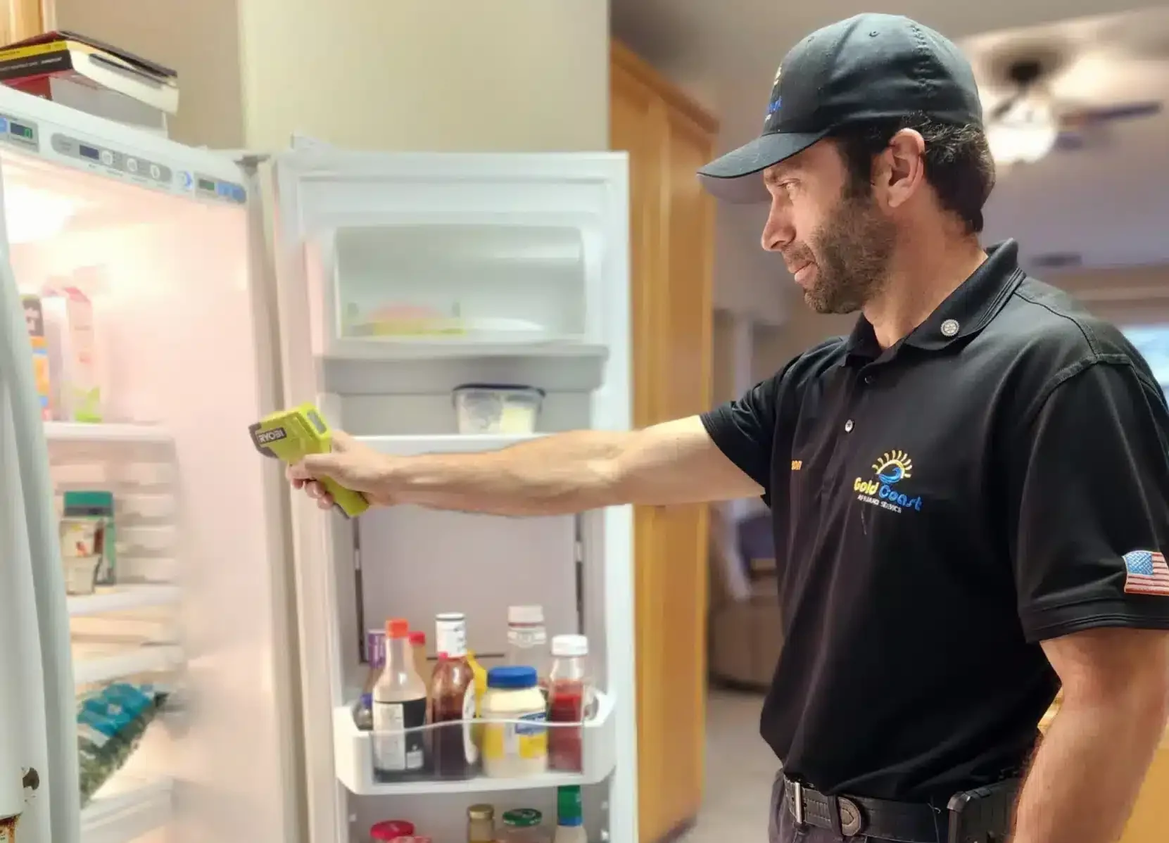 Refrigerator repair technician in Brentwood servicing an open refrigerator