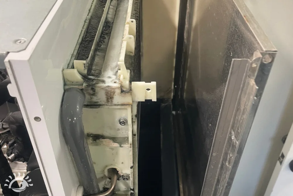 Close view of the evaporator and metal panels inside a Scotsman ice machine during service