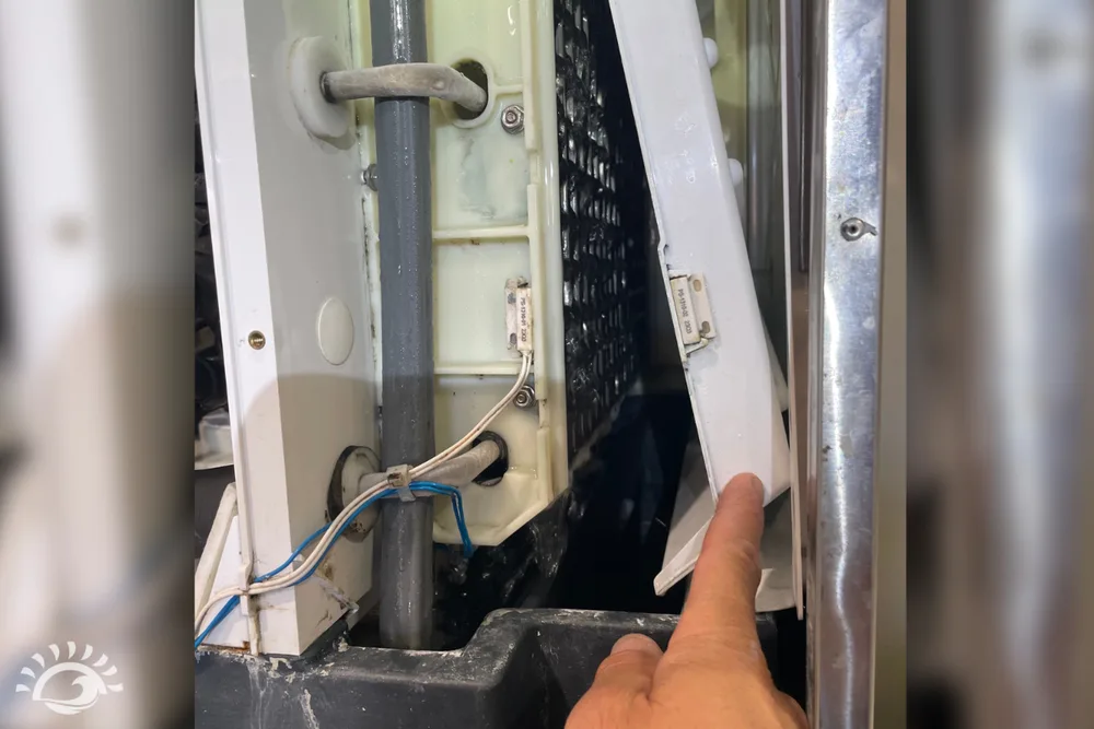 Technician pointing to the water trough and distribution area inside a Scotsman ice machine