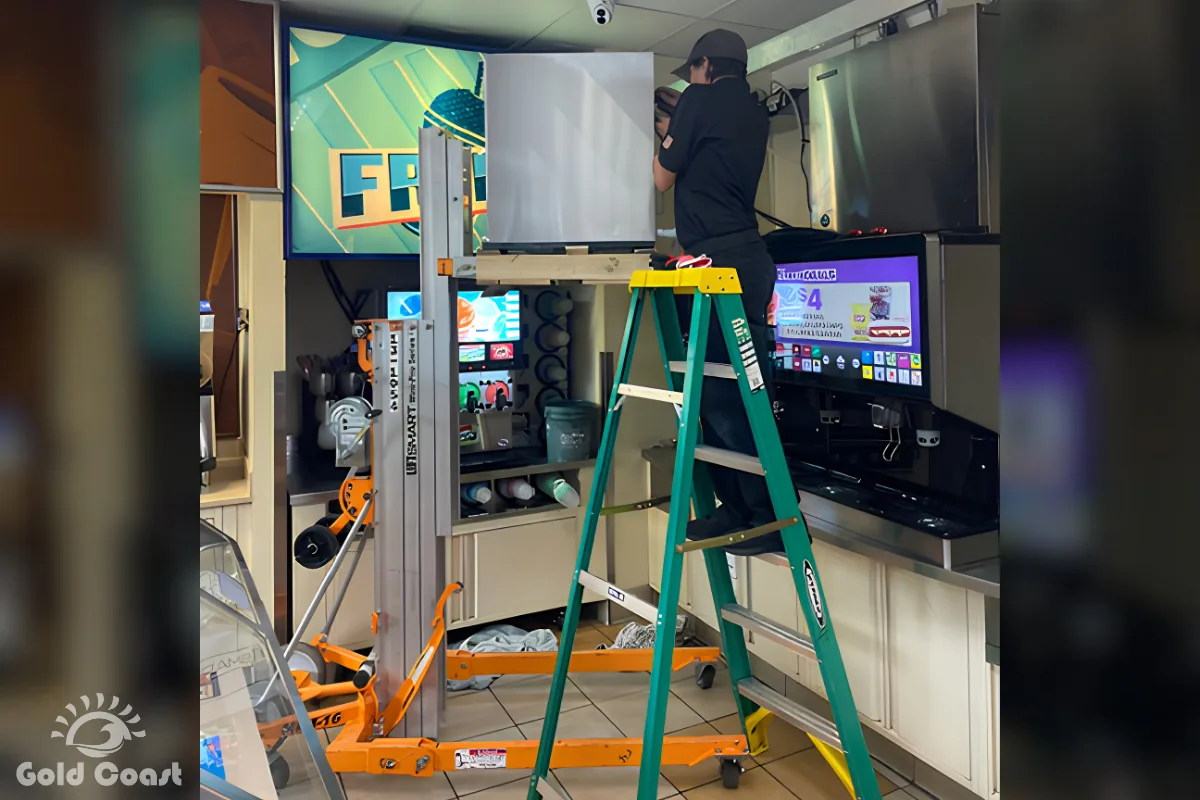 Gold Coast technician using proper access equipment to service a commercial ice machine